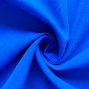 Macro detail of the bright royal blue textile fabric showing fine weave texture.