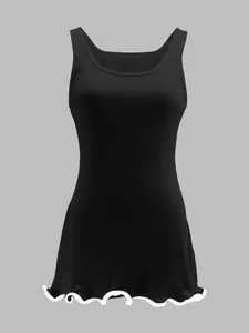Detailed view of black ribbed sleeveless dress with white ruffled wave hem