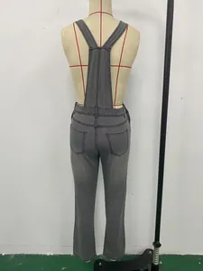 Detailed back view showing the fit and pockets of slim grey denim overalls for women.