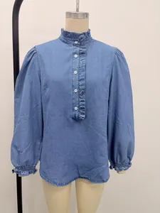Close-up front view of a blue denim blouse featuring ruffle collar and puff sleeves