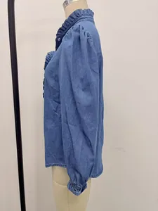 Side view detail of a blue denim shirt featuring puff sleeves and ruffle collar accents.