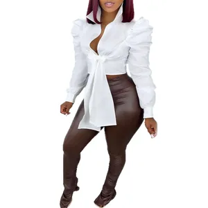 Sexy white puff shoulder long sleeve shirt featuring a front tie waist and deep v-neck
