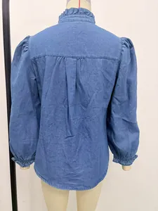 Detailed back view of a light blue denim shirt featuring ruffled collar and puff sleeves