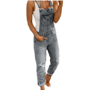 Slim fit women's distressed denim overalls jumpsuit in light blue wash with ripped details