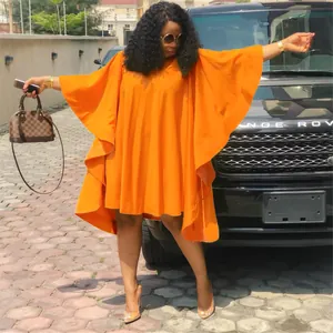 Gros plan sur la robe plissée orange vif de grande taille avec des manches chauve-souris