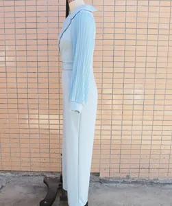 Side view of a light blue long-sleeved jumpsuit featuring elegant pleated sleeve details