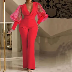 Elegante tuta rossa con maniche a sbuffo in mesh trasparente e scollo a V profondo da donna