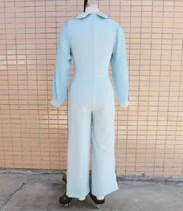 Detailed back view of a light blue jumpsuit featuring pleated long sleeves and a slim waist