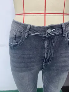 Close-up detail of high-waist grey washed denim jeans with white contrast stitching