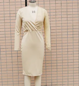 Detail showing lace splice on champagne slim bodycon dress with elegant V-neck