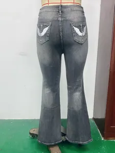 Women's vintage grey washed flare jeans featuring white wing embroidery on back pockets