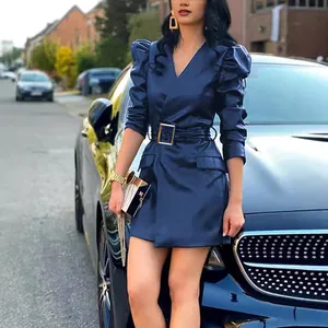 Close-up of stylish navy blue faux leather V-neck dress with puff sleeves and belt