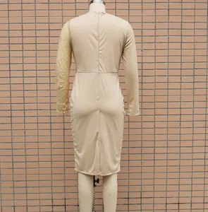 Back view of elegant apricot bodycon dress with lace sleeve detail on display mannequin