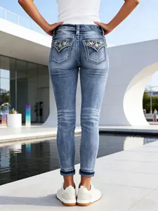 Women's slim stretch embroidered denim jeans skinny pants in a light blue wash
