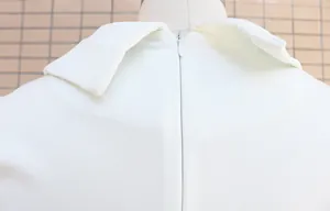 Detailed back view of a white slim-fit bodysuit showing the zipper and blazer collar.