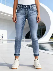 Stylish slim-fit women's stretch denim jeans with embroidered pockets and faded blue wash
