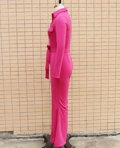 Side view of magenta long-sleeve jumpsuit featuring a shirt collar and matching waist belt