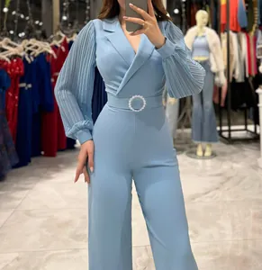 Elegant light blue jumpsuit featuring pleated sleeves and a sparkly belt detail