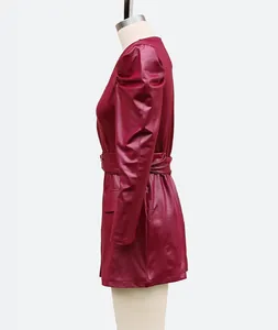 Side view detail of a chic burgundy faux leather dress with stylish puff sleeves.