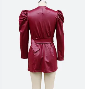 Back view of burgundy faux leather mini dress featuring stylish puff sleeves and waist belt