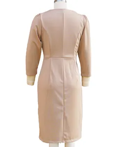 Detailed back view of a slim-fit beige long-sleeved midi dress on a tailor mannequin
