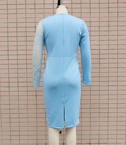 Back view of light blue bodycon dress with lace patchwork sleeve and slit detail.