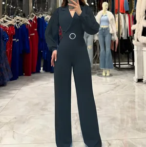 Elegant deep green jumpsuit with pleated long sleeves and a sophisticated suit collar