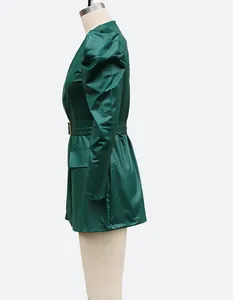 Detail side view of a dark green faux leather dress with puff sleeves and belt.
