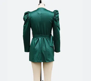 Detailed back view of a stylish green faux leather puff sleeve mini dress on a mannequin