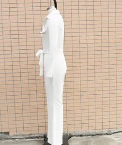 Side view detail of a white long-sleeved jumpsuit featuring shirt collar and waist belt