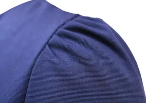 Close-up detail showing the navy blue knitted fabric texture and pleated shoulder design