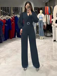 Elegant navy blue long sleeve pleated jumpsuit with professional blazer collar and belt