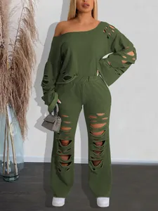 Detailed view of women's distressed two-piece set with off-shoulder sweatshirt and ripped pants