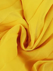 Close-up of vibrant yellow pleated fabric showing fine texture and drape