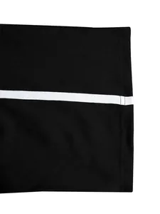 Macro close-up showing the white stripe detail on premium black athletic wear fabric.