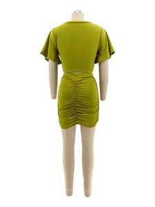 Back view of olive green two-piece set featuring ruched mini skirt and crop top