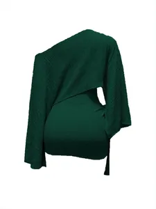 Detailed view of the dark green ribbed fabric on this one-shoulder top and mini skirt set
