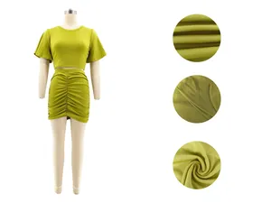 Detailed view of olive green two-piece ruched skirt set showing fabric and seams