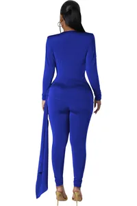 Back view of a royal blue long-sleeved skinny jumpsuit with shoulder pads and side drape