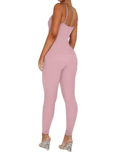 Back view of a pink ribbed camisole jumpsuit on a model showing slim fit texture