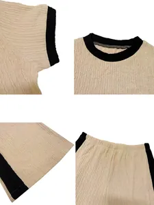 Close-up details of apricot crinkle fabric two-piece set with black contrast trim