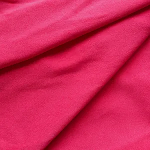 Detailed close-up showing the high-quality hot pink knit fabric texture of an office dress