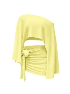Detailed view of yellow crinkled fabric on one-shoulder top and tie-side mini skirt