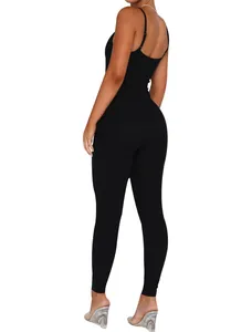 Back view of a sleek black backless jumpsuit featuring slim spaghetti straps and fit.