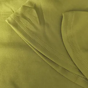 Close-up detail of olive green fabric and high-quality stitching on fashion two-piece set.