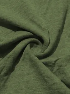 Close-up of olive green knitted fabric showing detailed texture and soft folds.