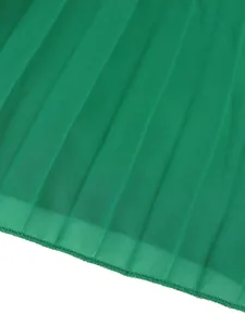 Detailed view of emerald green pleated fabric texture and professional hemline finish