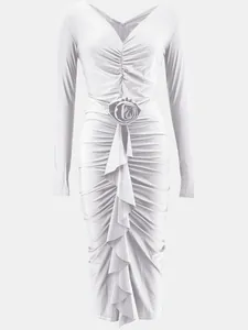 Detailed view of white long sleeve V-neck bodycon dress featuring 3D rose accent