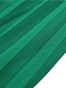 Macro view of vibrant green pleated fabric texture on high-waist wide-leg trousers.