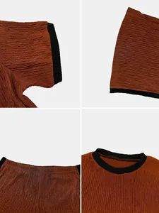 Close-up of textured fabric and contrast stitching on burnt orange two-piece set